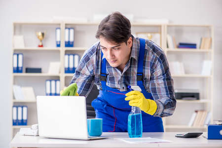 Cleaner man cleaning the officeの写真素材