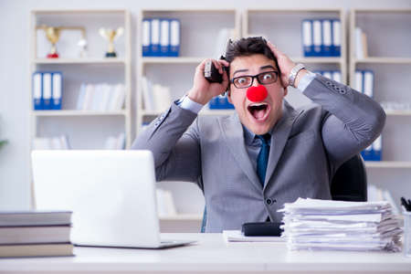 Clown businessman working in the office angry frustrated with aの写真素材