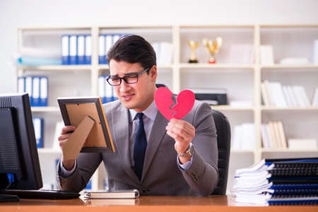 Businessman in saint valentine concept in officeの写真素材