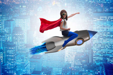 Little girl flying rocket in superhero conceptの写真素材