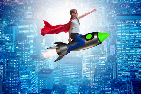 Little girl flying rocket in superhero conceptの写真素材