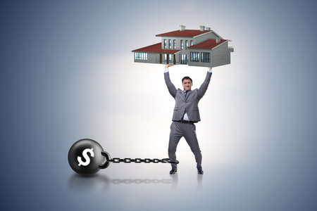 Businessman in mortgage debt financing conceptの写真素材