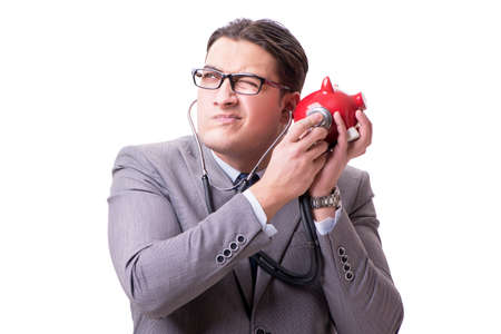Businessman with stethoscope and piggybank isolated white backgrの写真素材