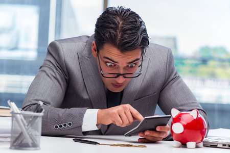 Bankrupt broke businessman with piggy bankの写真素材