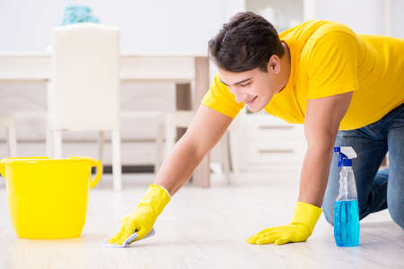 Young man doing chores at homeの写真素材