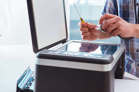 Repairman repairing broken color printer