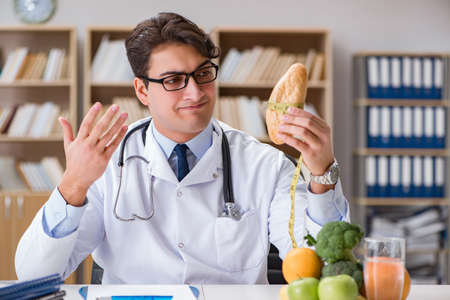 Scientist studying nutrition in various foodの写真素材