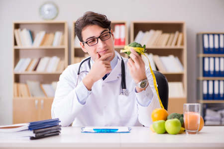 Scientist studying nutrition in various foodの写真素材
