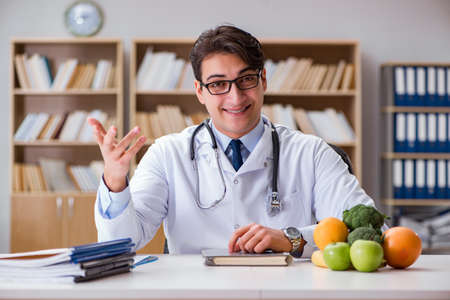 Scientist studying nutrition in various foodの写真素材