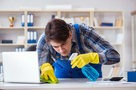 Male cleaner working in the officeの写真素材