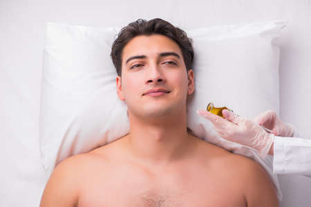 Handsome man in spa massage conceptの写真素材