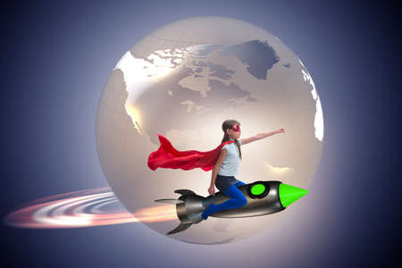 Little girl flying rocket in superhero conceptの写真素材
