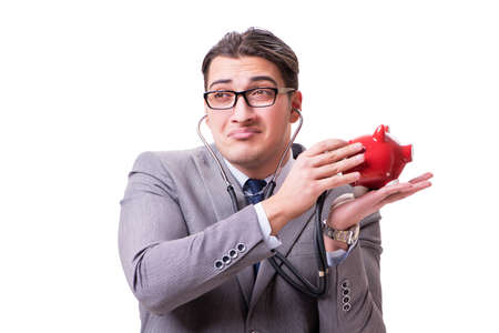 Businessman with stethoscope and piggybank isolated white backgrの写真素材