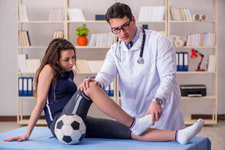 Man doctor taking care of sports injuryの写真素材