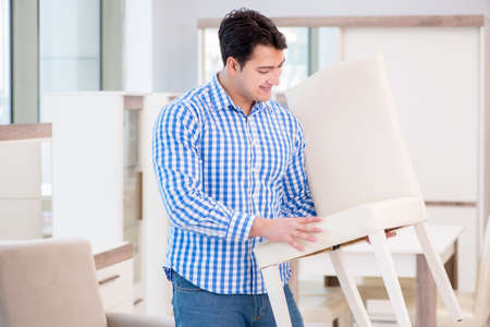 Young man shopping in furniture storeの写真素材