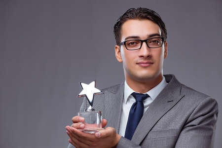 Businessman holding star award in business conceptの写真素材