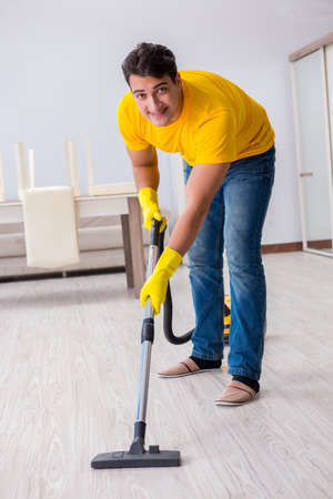 Young man doing chores at homeの写真素材