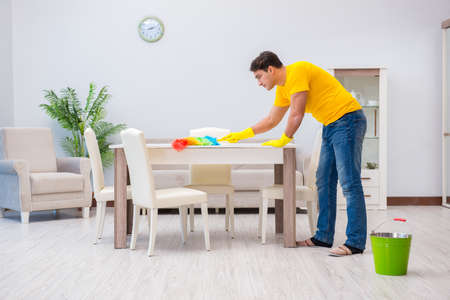 Young man doing chores at homeの写真素材