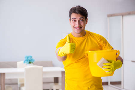 Young man doing chores at homeの写真素材