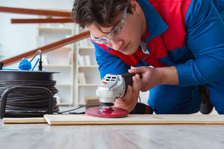 Young carpenter working with wooden planks