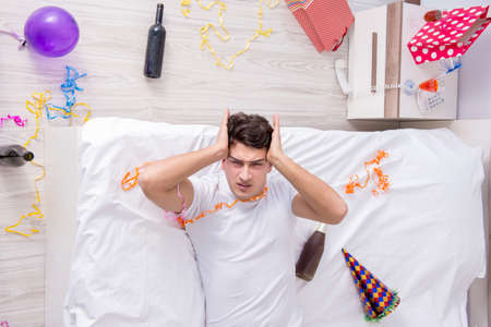 Young man after the wild Christmas partyの写真素材