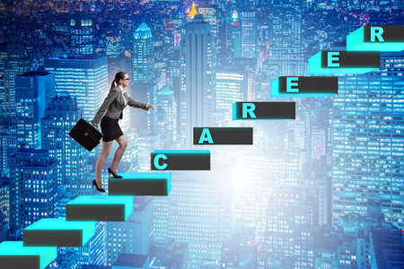 Businesswoman climbing career ladder in business conceptの写真素材
