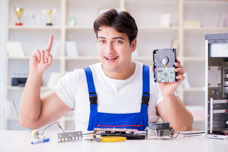 Computer repairman repairing desktop computerの写真素材