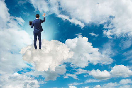 Businessmam pressing virtual buttons in the skyの写真素材