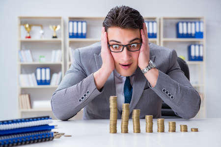 Businessman with golden coins in business growth conceptの写真素材