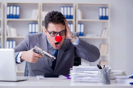 Clown businessman working in the office angry frustrated with aの写真素材