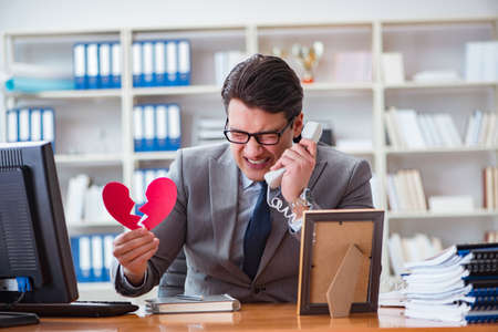 Businessman in saint valentine concept in officeの写真素材
