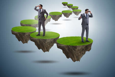 Businessman on flying island with binocularsの写真素材