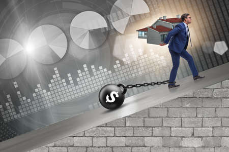 Businessman in mortgage debt financing conceptの写真素材