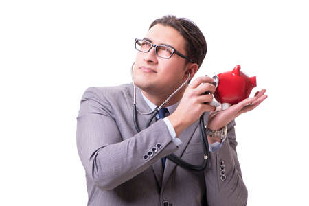 Businessman with stethoscope and piggybank isolated white backgrの写真素材