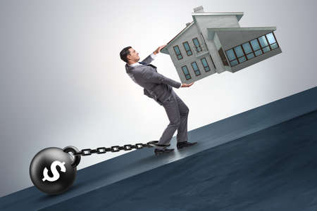 Businessman in mortgage debt financing conceptの写真素材