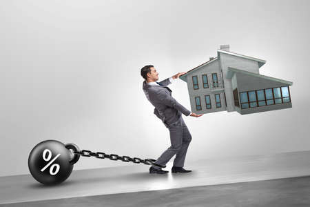 Businessman in mortgage debt financing conceptの写真素材