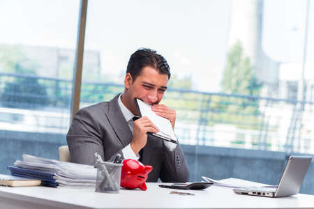 Bankrupt broke businessman with piggy bankの写真素材