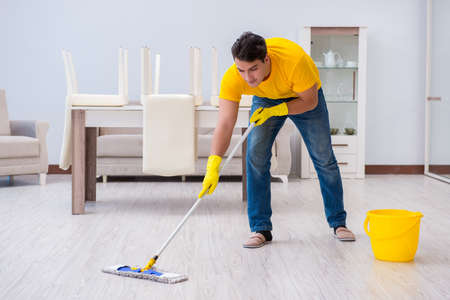 Young man doing chores at homeの写真素材