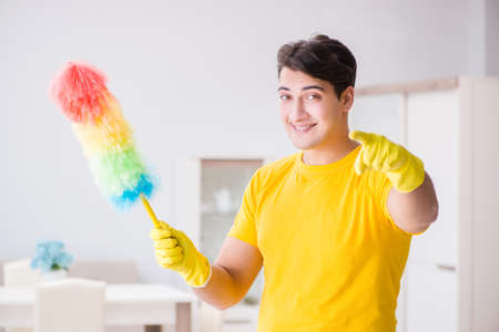 Young man doing chores at homeの写真素材
