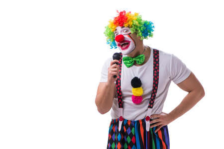 Funny clown with a microphone singing karaoke isolated on whiteの写真素材