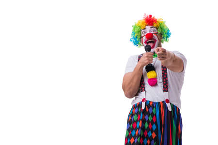 Funny clown with a microphone singing karaoke isolated on whiteの写真素材