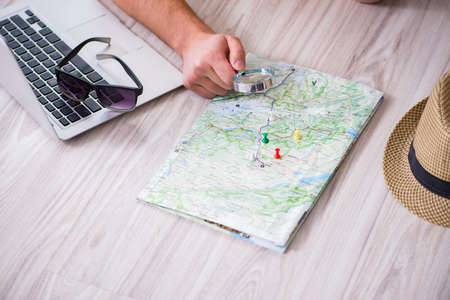 Man planning his vacation trip with map