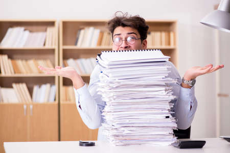 Mad businessman with piles of papers