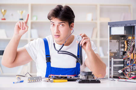 Computer repairman repairing desktop computerの写真素材