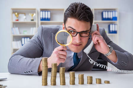 Businessman with golden coins in business growth conceptの写真素材