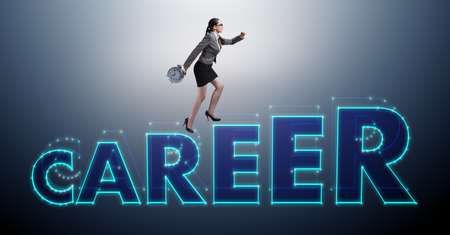 Businesswoman climbing career ladder in business conceptの写真素材