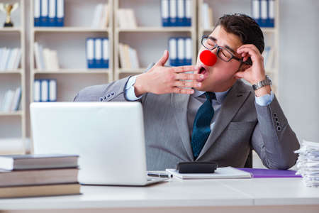 Clown businessman tired sleepy in the officeの写真素材