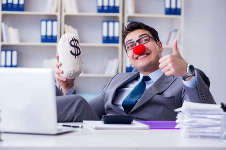 Clown businessman in the office with the a money sackの写真素材