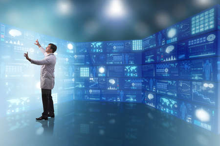 Doctor in telemedicine concept pressing buttonsの写真素材