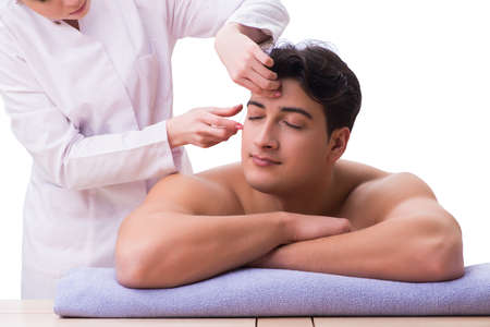 Handsome man in spa massage conceptの写真素材